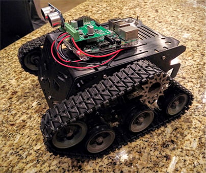 Devastator chassis, controller board, a motor control expansion board, and an ultrasonic sensor Image of Devastator chassis, controller board, a motor control expansion board, and an ultrasonic sensor